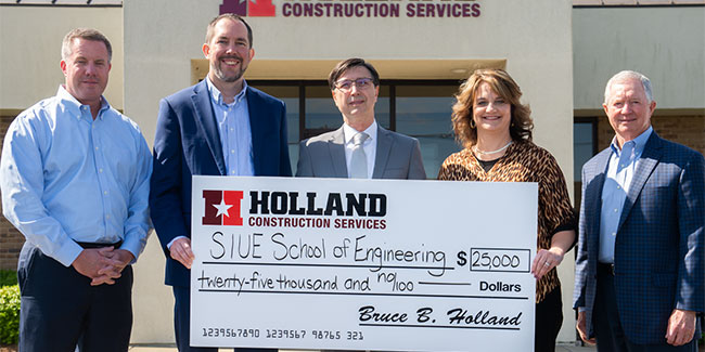 A group photo holding a check from Holland Construction Services addressed to the SIUE School of Engineering