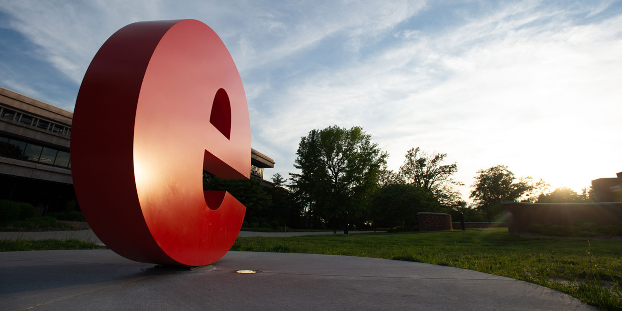 The "e" in front of Rendleman Hall at sunset.