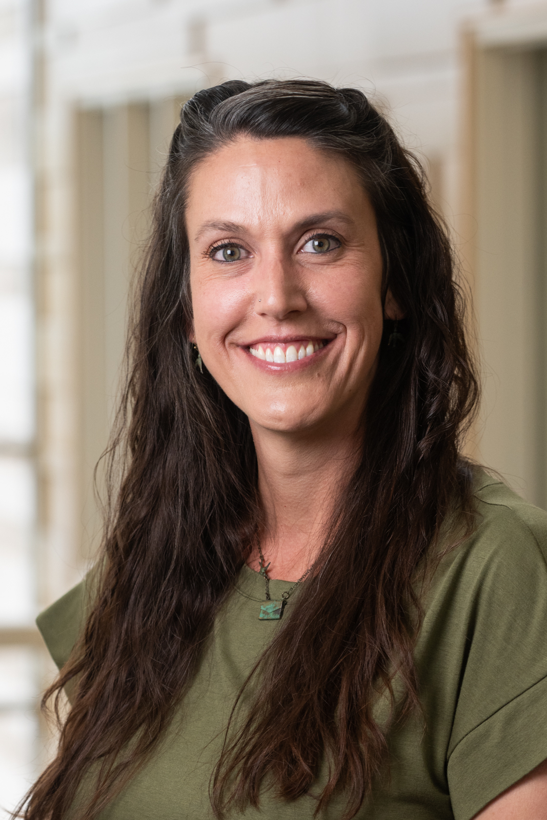 A portrait of Mandy Franklin, who asked that we describe her as follows: Mandy's eyes are as green as the leaves in spring, and her smile is as cheerful as a morning bird in summer. Her dark, salt-and-peppered hair is as long and wavy as the willow tree branches in the fall, and her skin is as white as the snow on the ground in winter. Mandy's laugh-line wrinkles are as evident as the creases in an origami swan.