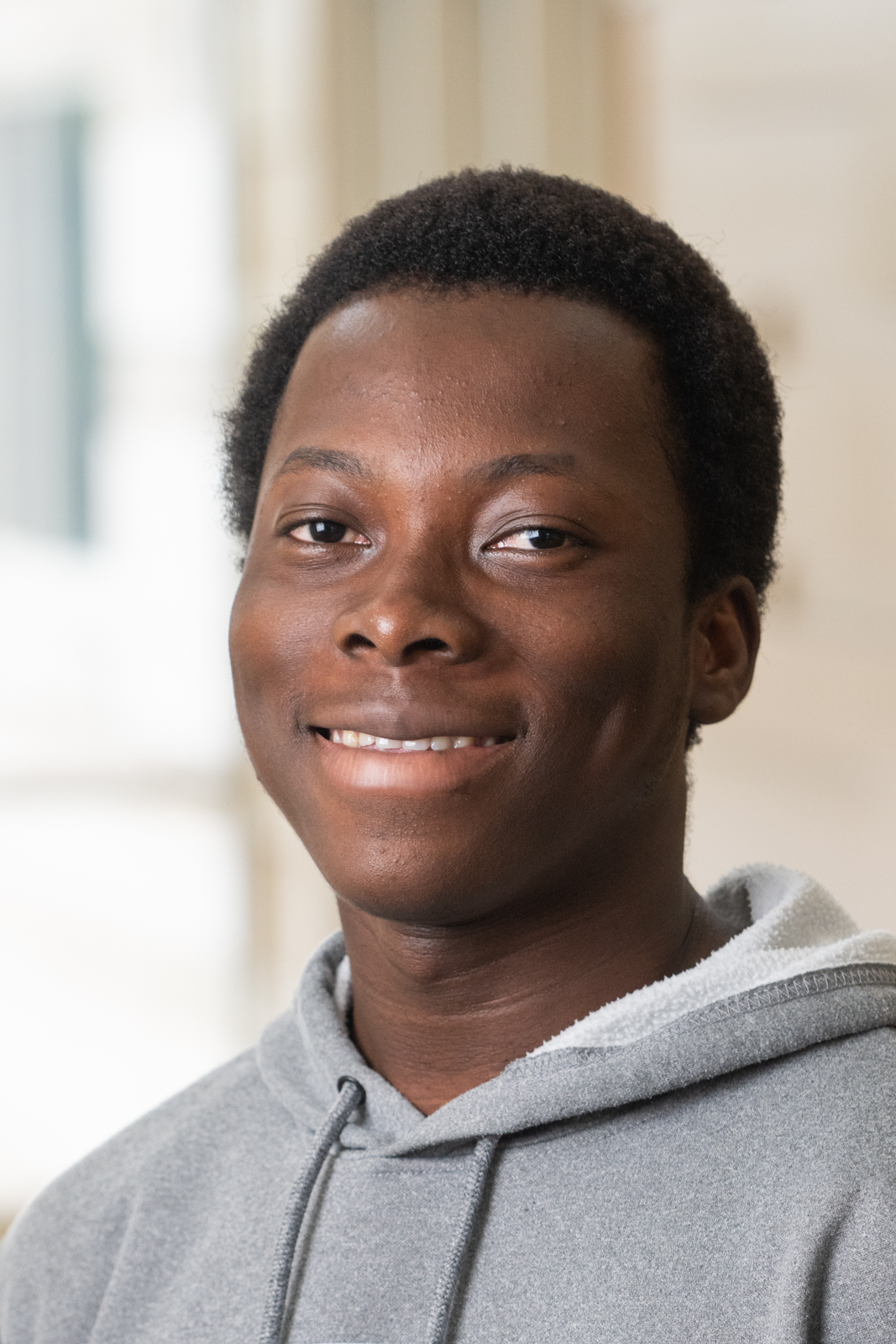 Black male with grey hooded sweatshirt