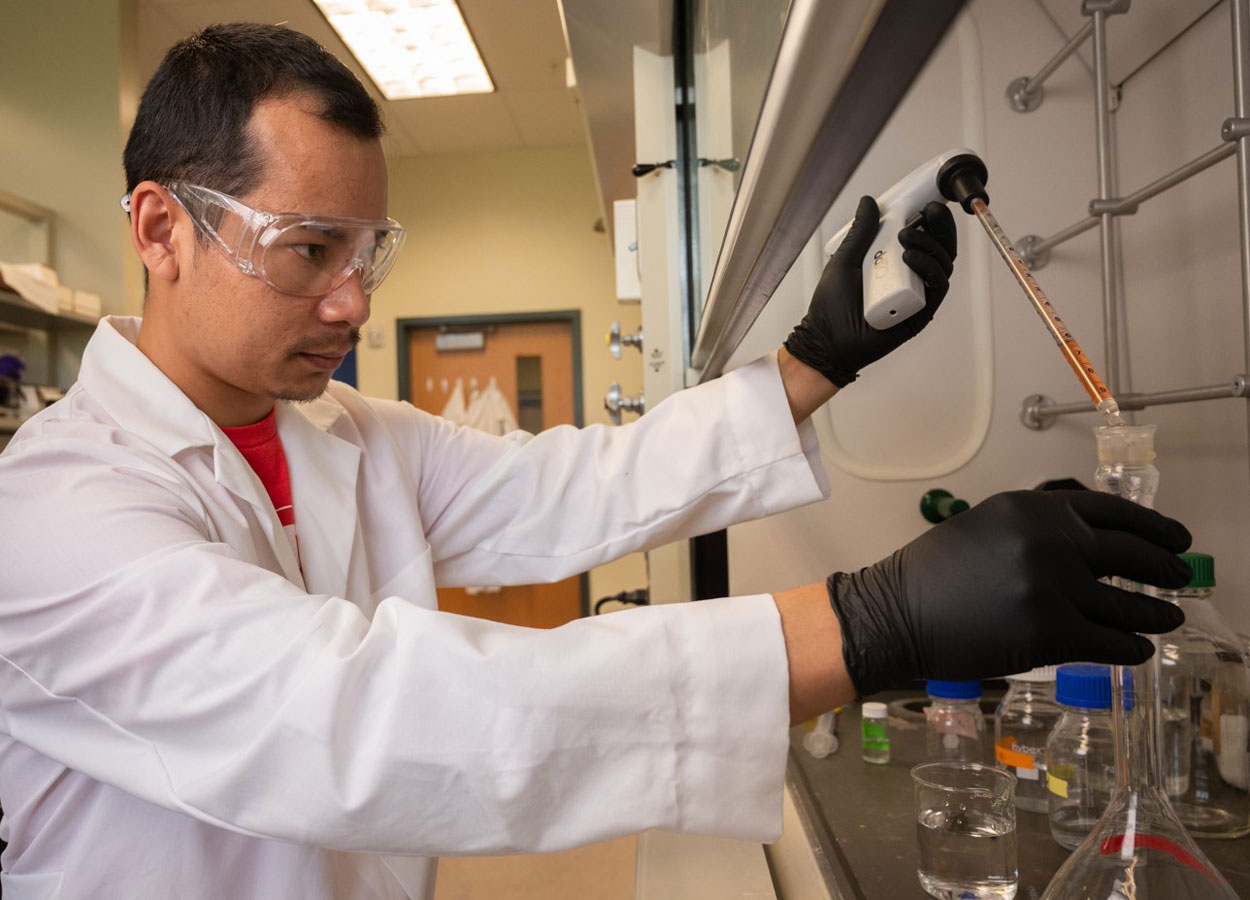 A student in the lab carrying out an experiment