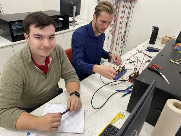 Two students at table working on engineering project